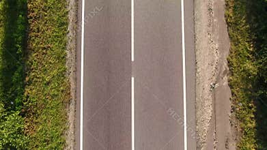 Aerial view car driving on country road, luxury car driving through mist at dusk with headlights
