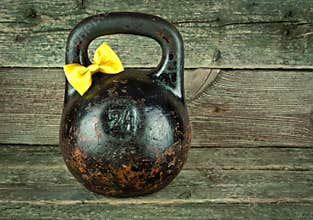 Vintage Old kettlebell on a wooden background