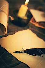 Old desk with vintage stationery in candlelight