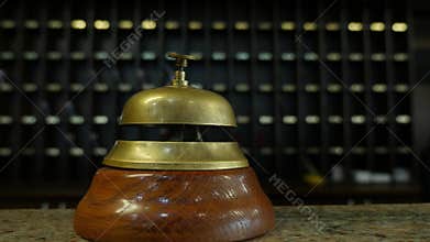 Footage of a person ringing on a bell at a hotel reception