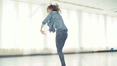 Young pretty girl dancing hip-hop in dance studio in 4K