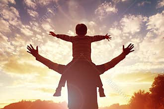 Family time father and son watch the sunset