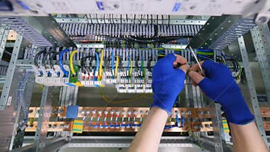 Professional electrician manufacturing industrial control cabinet.