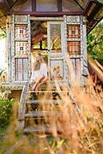 Pretty blonde woman and antique gypsy caravan 5