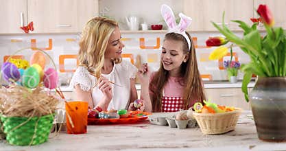 Easter painting â€“ mother with daughter coloring eggs