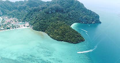 Aerial drone video of iconic tropical beach and resorts on Phi Phi island and Yong Kasem Bay called Monkey beach