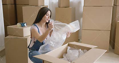 Smiling happy woman packing up her home