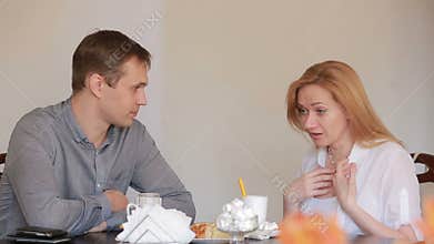 Couple quarrel in a cafe, separation, emotional conversation. Man and woman