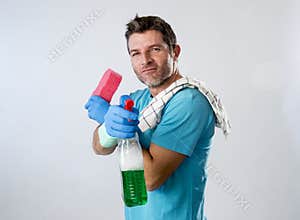 Man smiling happy doing house cleaning holding spray bottle and sponge
