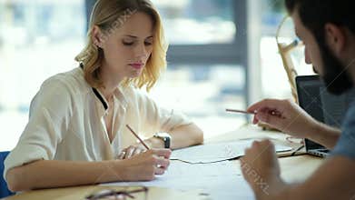 Thoughtful young freelancer listening to ideas of business partner