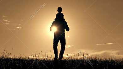 Father carries his son on his shoulders.