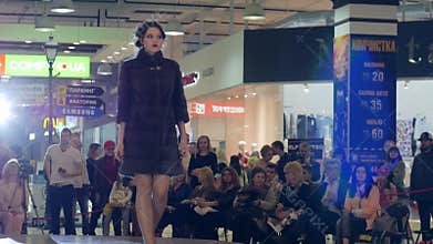 Stylish Fur coats On Model in high-heeled shoes on catwalk, Fashion show, presentation of new collection