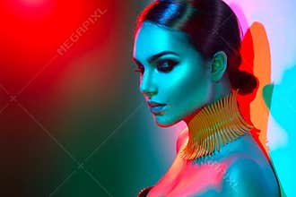 Fashion model woman in colorful bright lights posing