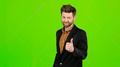 Male businessman showing thumbs up, he likes everything. Green screen