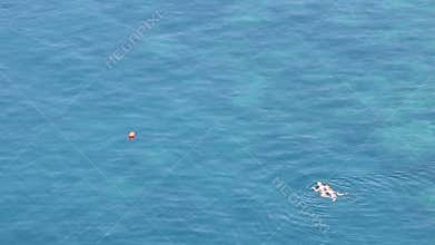 Man and woman swim in the sea