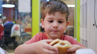 Kid plays with harmful food at table, Hamburger and French fries for snack for son, Oily food in school cafeteria for
