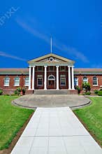 Classic Red Brick Building With Greek White Column Entrance