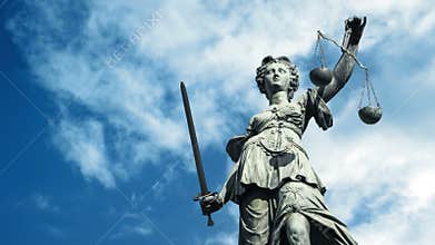 Statue Of Lady Justice With Clouds Passing