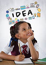 Schoolgirl writing at desk with idea graphics