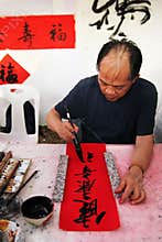 Old artist are writing Chinese hieroglyphs on Chinese New Year. Bangkok, Thailand.