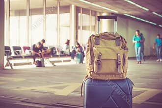 Suitcases and backpack in airport departure terminal with travel