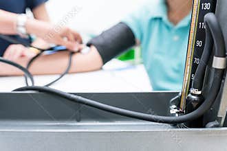 Nursing students are training measurement of blood pressure with manual sphygmomanometer and stethoscope at nursing school.