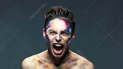 Angry young man screaming isolated.