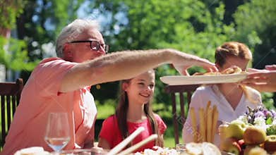 Happy family having dinner or summer garden party