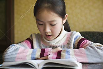 Asian girl reading a book