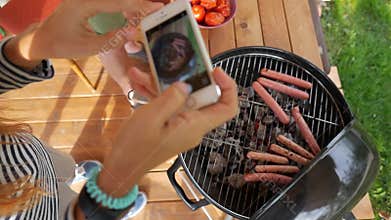 Girl making photo of grill sausages and tomatoes. Vegan bbq party. HD slowmotion