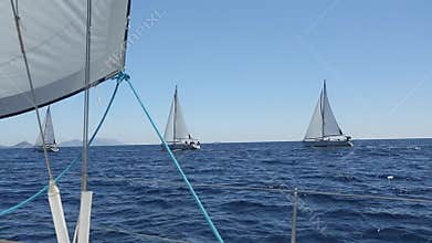 Ship yachts with white sails in the open sea. Sailing. Yachting. Tourism. Luxury Lifestyle. Boat in sailing regatta