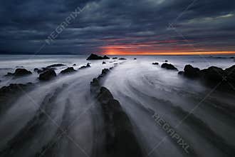 Flysch rocks in barrika beach at sunset
