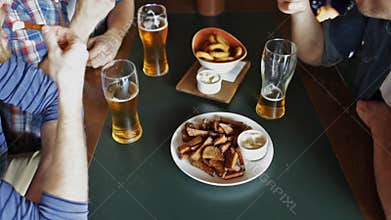 Happy male friends drinking beer at bar or pub