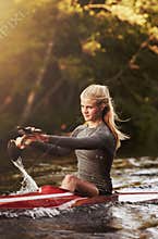 Athletic woman kayaking