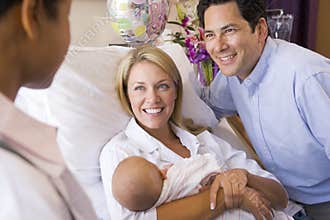 New parents with baby talking to doctor
