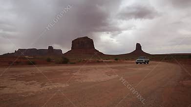 Car passing Monument Valley