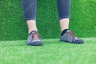 Feet of young woman on astro turf