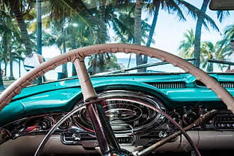 HDR Cuba interior view from a american classic car with view on the beach