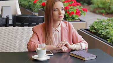 Girl waving hand in cafe