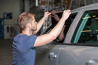 Applying tinting foil onto a car window