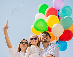 Family with balloons outdoors