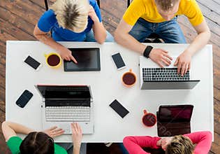 Students sitting at the table using computers