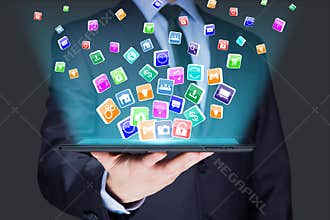 Businessman holding a tablet pc with mobile applications icons on virtual screen . Internet and business concept.