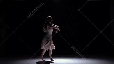 Modern dancer girl in white dress continue dancing contemporary on black, shadow, slow motion