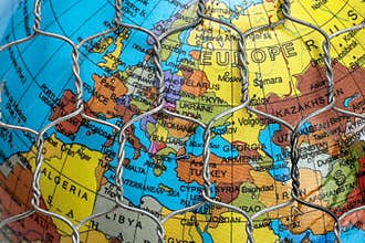 The global map behind a wire fence