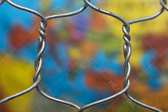 Global map behind a wire fence