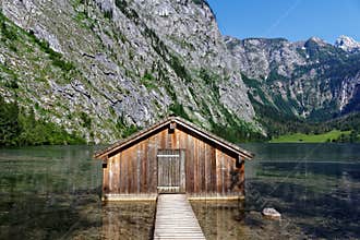 Boathouse in alpine mountain lake scenery