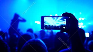 Fans waving their hands and hold the phone with digital displays