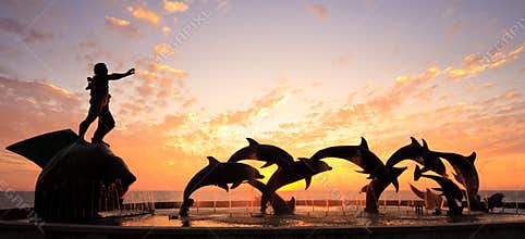 Sunset with statue of Dolphins