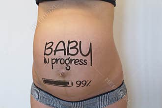 Pregnant belly with sign
